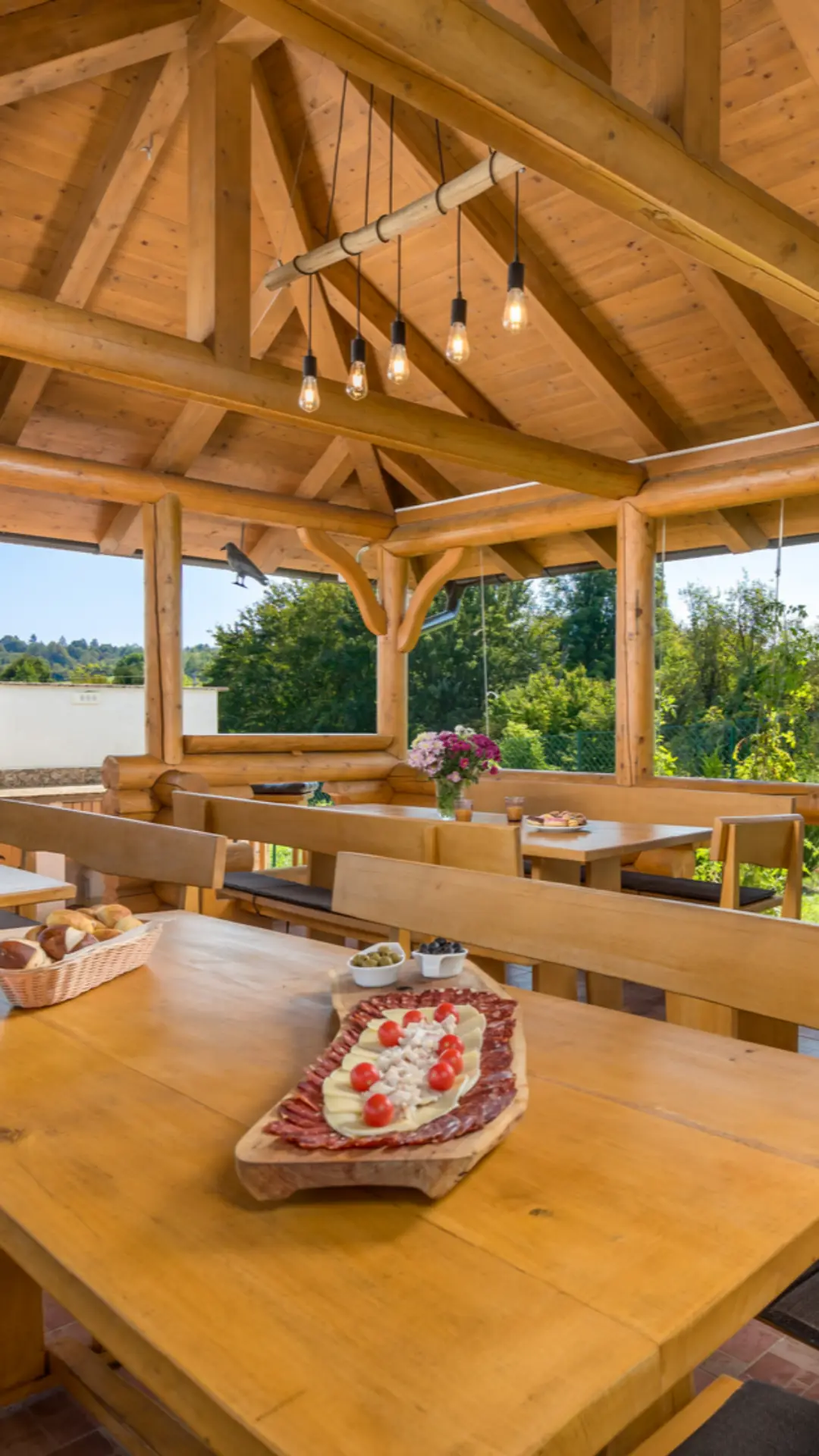 Table set with food in the wooden gazebo