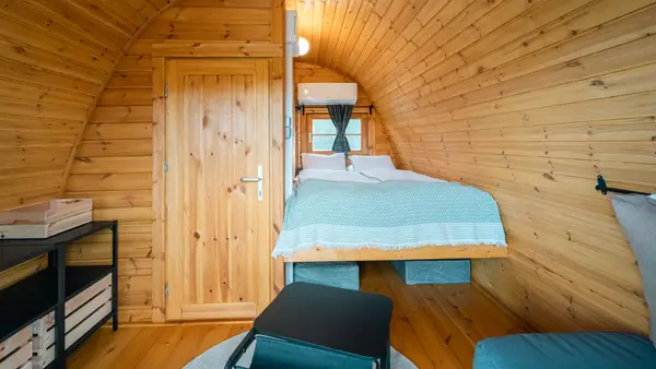 Inside a glamping cabin: double bed and air conditioning