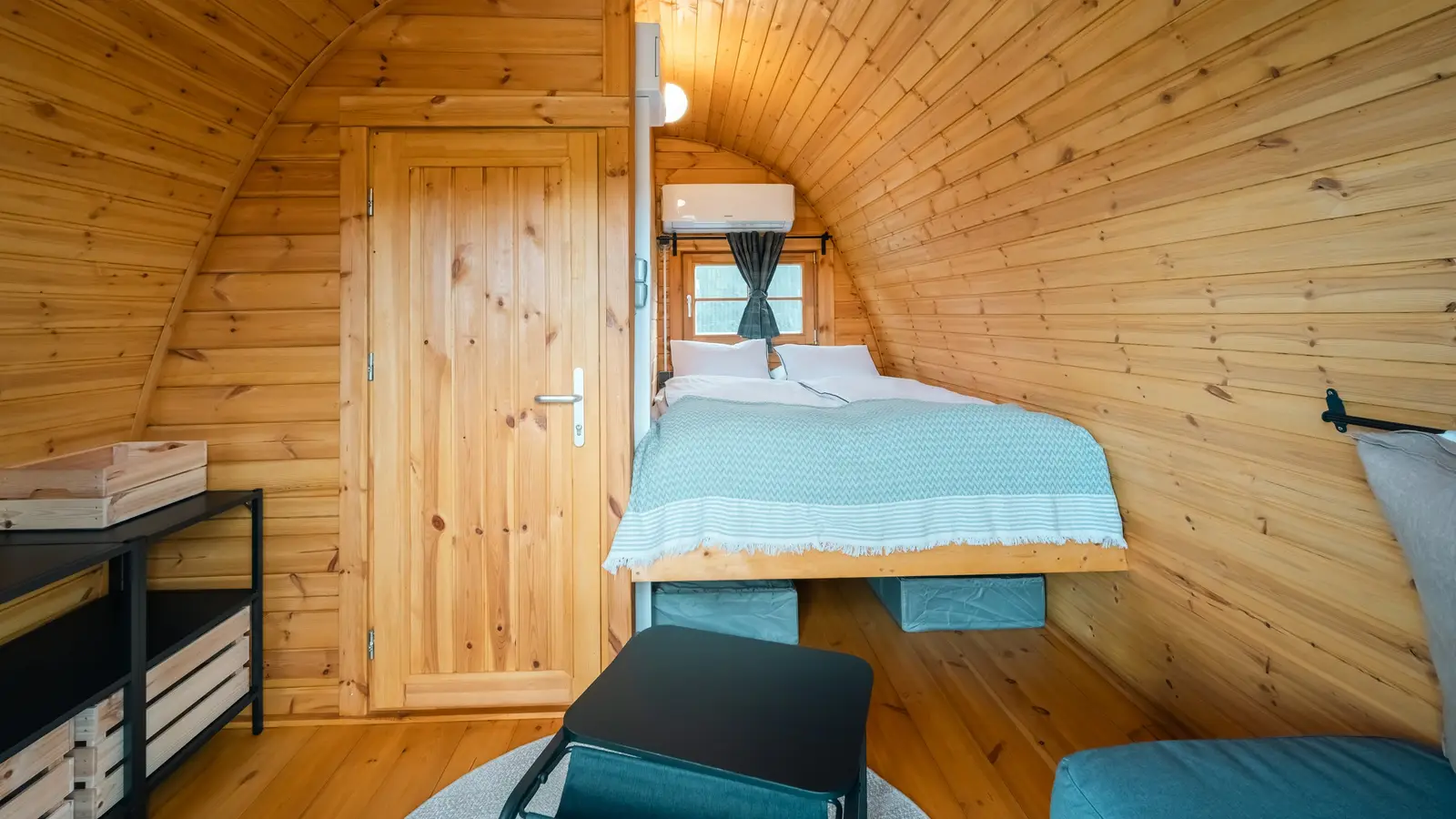 Inside a glamping cabin: double bed and air conditioning